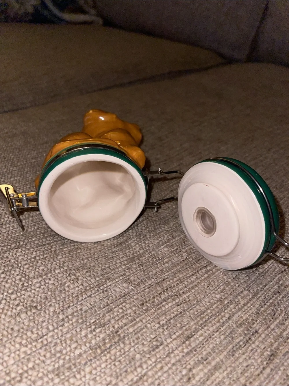 Ceramic dog figurine that has storage in the bottom.